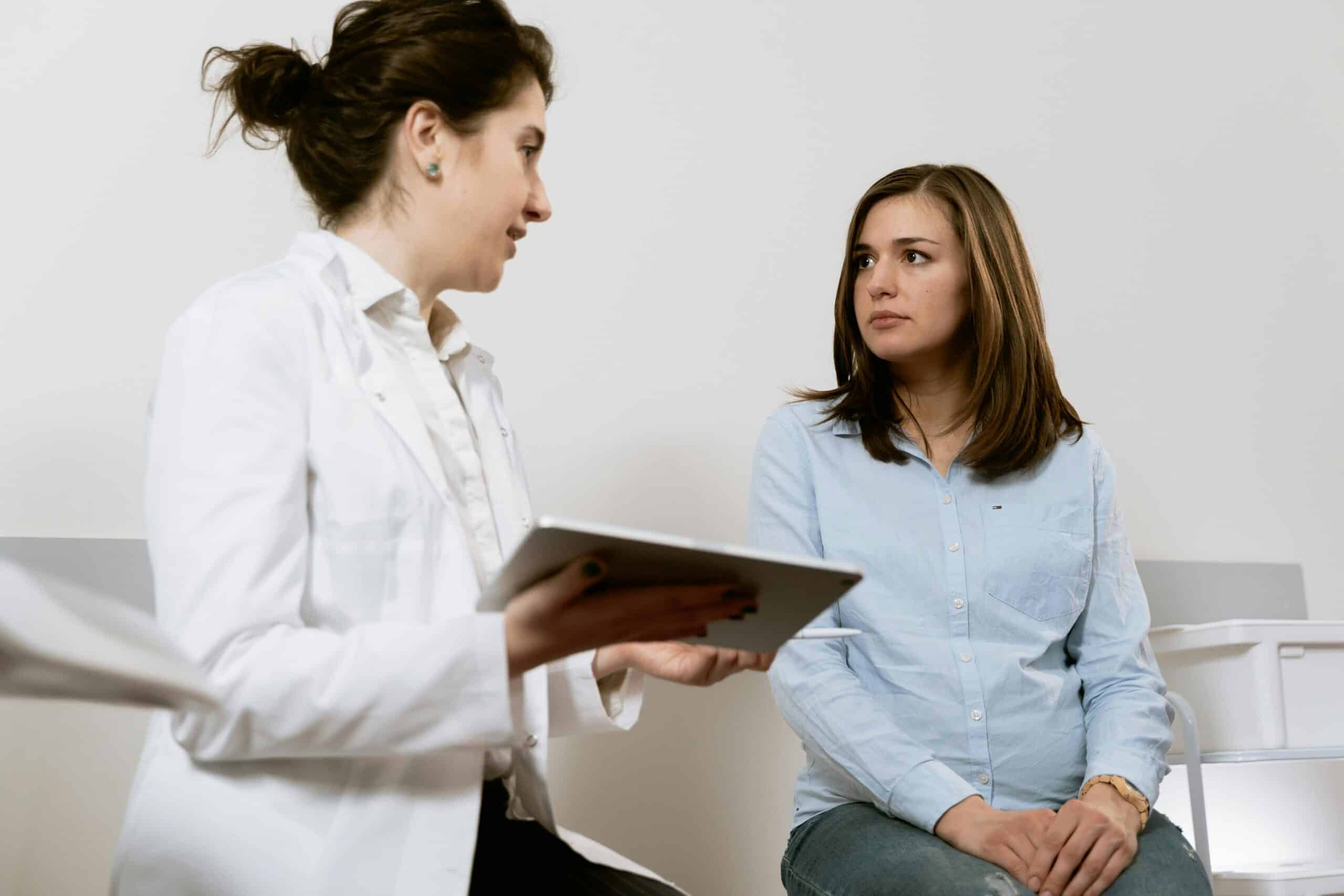 Doctor discussing thyroid health with a patient in a clinical setting, focusing on personalized care and diagnosis